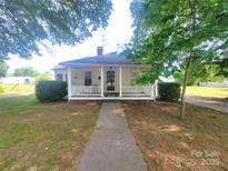 Charming home featuring a quaint front porch and well-manicured lawn at 309 E 11Th St, Kannapolis, NC 28083