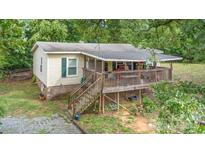 Charming home featuring a spacious deck and a well-maintained yard at 5523 Flint Ridge Church Rd, Marshville, NC 28103