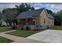 Charming home featuring a welcoming front porch and well-maintained lawn at 615 Grier St, Lincolnton, NC 28092