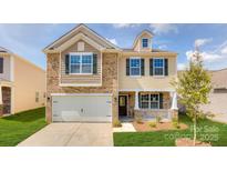 Charming two-story home with brick and siding exterior, a well-manicured lawn and attached garage at 9528 Maltese Dr, Gastonia, NC 28056