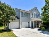 Charming two-story home with a two-car garage and a well-maintained front yard under a clear blue sky at 1124 Hunter St, Statesville, NC 28677