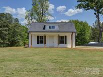 Charming home with vertical siding, black shutters, and inviting front porch at 1454 King Rd, York, SC 29745