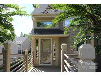 Inviting front entrance with a screen door, partial railing, and number 14621 displayed at 14621 Waterside Dr, Charlotte, NC 28278