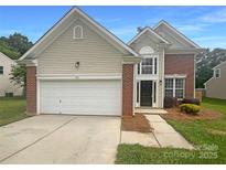Charming home featuring a two-car garage, manicured lawn and brick and siding accent at 177 Jacobs Woods Cir, Troutman, NC 28166