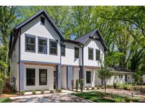 Modern two-story home with white siding, black trim, and a well-manicured lawn at 2006 St John St, Charlotte, NC 28216