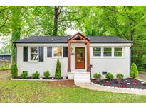 Charming renovated home with a brick exterior, updated landscaping and a welcoming front porch at 3120 Parkway Ave, Charlotte, NC 28208