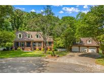 Charming two-story brick home with lush landscaping and a three-car garage in a desirable neighborhood at 341 N Mulberry St, Statesville, NC 28677