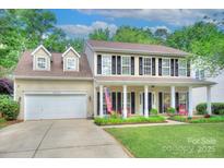 Charming two-story home featuring a welcoming front porch and well-maintained landscaping at 3632 Cole Mill Rd, Charlotte, NC 28270