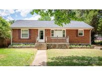 Charming single-story brick home with a stone foundation and inviting front porch at 734 Club Dr, Statesville, NC 28677