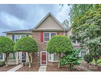 Charming brick townhome with mature landscaping and a welcoming front entrance at 8221 Pineville Matthews Rd # G, Charlotte, NC 28226