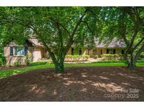 Charming brick home with mature landscaping and a welcoming entrance at 104 Ridge Dr, Stanley, NC 28164