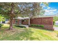 Charming brick home featuring mature landscaping, a welcoming entrance, and a well-maintained lawn at 1102 E 13Th St, Kannapolis, NC 28083