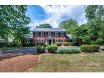 Beautiful brick home featuring a manicured front yard and classic black shutters at 1285 10Th Street Nw Blvd, Hickory, NC 28601
