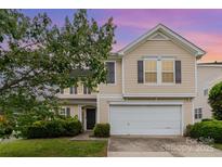 Two-story home featuring a two-car garage, traditional architecture, and lush landscaping at 13816 Riding Hill Ave, Charlotte, NC 28213