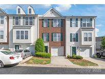 Inviting townhome featuring a brick facade, green shutters, and well-maintained landscaping at 1707 Kashmir White Ln, Fort Mill, SC 29708