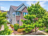 Beautiful two-story home with brick and vinyl siding, lush landscaping, and a well-maintained lawn at 17913 Ragtop Day Ln, Cornelius, NC 28031