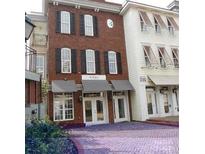 Charming townhouse exterior with brick facade, black shutters, and awnings over storefront entrances at 2092 Ayrsley Town Blvd, Charlotte, NC 28273