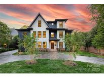 Beautiful two-tone home with modern design and professional landscaping, including a stamped concrete driveway at 2608 Croydon Rd, Charlotte, NC 28209
