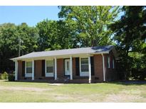 Charming brick home with a columned front porch and black shutters at 288 S Sutton Rd, Fort Mill, SC 29708