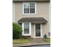 Charming townhome with covered entry, maintained lawn, and traditional architecture at 303 Heritage Pkwy, Fort Mill, SC 29715