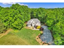 Stunning aerial view of a home surrounded by lush greenery and a winding driveway at 3610 Providence Mill Rd, Maiden, NC 28650