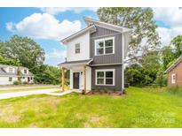 Charming two-story home with a modern gray and white exterior and newly planted landscaping at 424 Airline Ave, Shelby, NC 28150