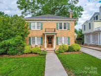 Charming two-story brick home with green shutters, landscaped yard, and inviting front porch at 907 Edgewood Cir, Gastonia, NC 28052