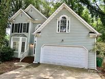 Charming two-story house boasts a convenient two-car garage and manicured lawn at 9907 Furlong Trl, Charlotte, NC 28269