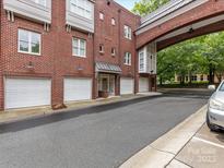 Charming brick condo building featuring attached garages and connecting bridge, ideal for city living at 100 N Laurel Ave # 107, Charlotte, NC 28207