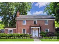 Charming brick home with a well-manicured lawn, classic architecture, and inviting front entrance at 1101 Pee Dee Ave, Albemarle, NC 28001