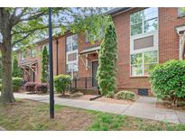 Charming red brick townhome with well-maintained landscaping, and a welcoming entrance at 119 Steinbeck Way # E, Mooresville, NC 28117