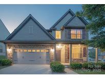 Charming two-story home featuring a stone facade and a spacious two-car garage at 159 Saye Pl, Mooresville, NC 28115