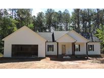 New construction home featuring a welcoming front porch, attached garage, and stylish exterior with trees in the background at 1761 Every Dr, Iron Station, NC 28080