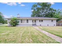 Charming single-story home featuring a brick facade, well-maintained lawn, and inviting curb appeal at 2001 Tyvola Rd, Charlotte, NC 28210