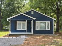 Charming blue home with white trim, black shutters, and a cozy front porch at 2123 W Sixth Ave, Gastonia, NC 28052