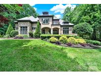 Charming stone and stucco home featuring a beautifully landscaped front yard with mature trees at 298 Horton Grove Rd, Fort Mill, SC 29715