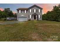 Charming two-story home with attached garage and well-maintained lawn at 3401 Shillinglaw Rd, Sharon, SC 29742