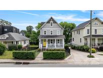 Charming two-story home featuring a welcoming front porch and a bright yellow front door at 423 State St, Charlotte, NC 28208