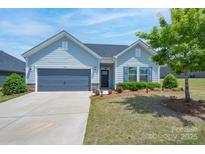 Charming single-story home with gray siding, a well-kept lawn, and a two-car gray garage at 5727 Lavaux Ct, Charlotte, NC 28214