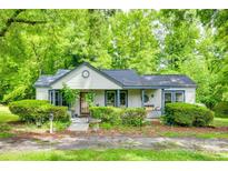 Charming single-story home featuring a quaint front porch and lush landscaping at 622 Neelys Creek Rd, Rock Hill, SC 29732