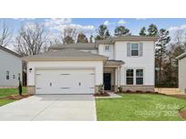Charming two-story home with a two-car garage, manicured lawn, and classic architectural details at 9948 Manor Vista Trl, Kannapolis, NC 28027