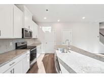 Bright kitchen with white cabinets, stainless steel appliances, granite countertops, and mosaic backsplash at 125 Canoga Ave, York, SC 29745