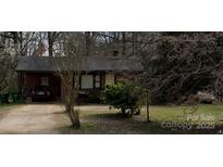 Charming one-story brick home with a large front yard and driveway, perfect for Gathering living at 13134 Homewood Dr, Charlotte, NC 28262