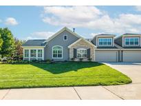 Charming home with stone accents, lush lawn, and a two-car garage on a sunny day at 1328 Somersby Cir, Gastonia, NC 28054