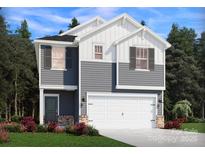 Charming two-story home with a two-car garage, gray horizontal siding, and lovely landscaping at 1421 Wildflower St, Newton, NC 28658
