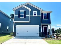 Charming two-story home featuring navy blue siding, white trim, a two-car garage and manicured landscaping in front at 1421 Wildflower St, Newton, NC 28658
