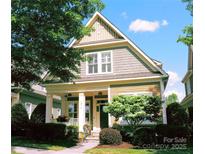 Charming two-story home featuring a welcoming front porch, well-manicured landscaping, and a freshly painted exterior at 15714 Laurel Oak Cres, Davidson, NC 28036