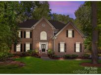 Charming brick home with manicured lawn, black shutters, and a welcoming front entrance at 15831 Breton Brook St, Huntersville, NC 28078