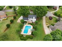 A home with a backyard pool surrounded by landscaped grounds in a well-kept neighborhood at 188 Turnberry Ln, Mooresville, NC 28117