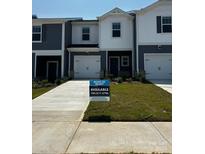 Charming townhouse with a well-manicured lawn and a 'move-in ready' sign at 4213 Summit Woods Dr, Charlotte, NC 28216